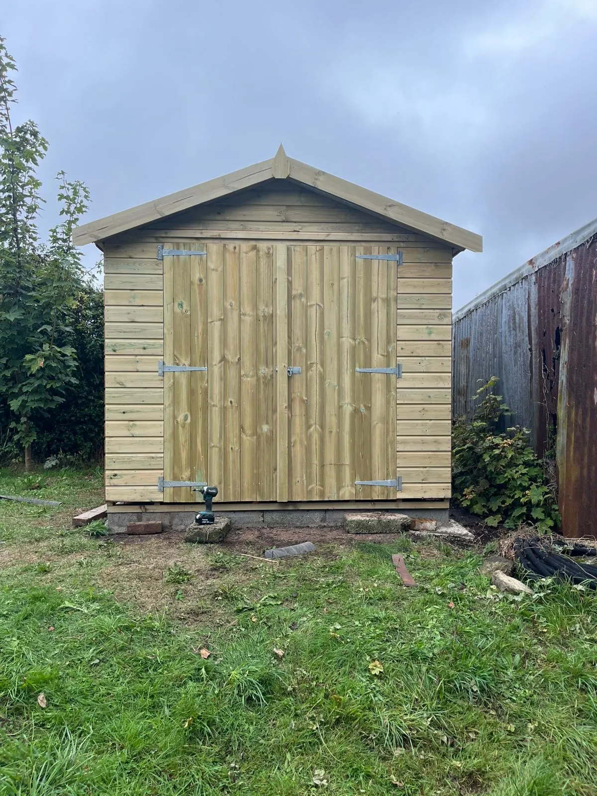 Large completed timber workshop with double doors in a Cornwall garden