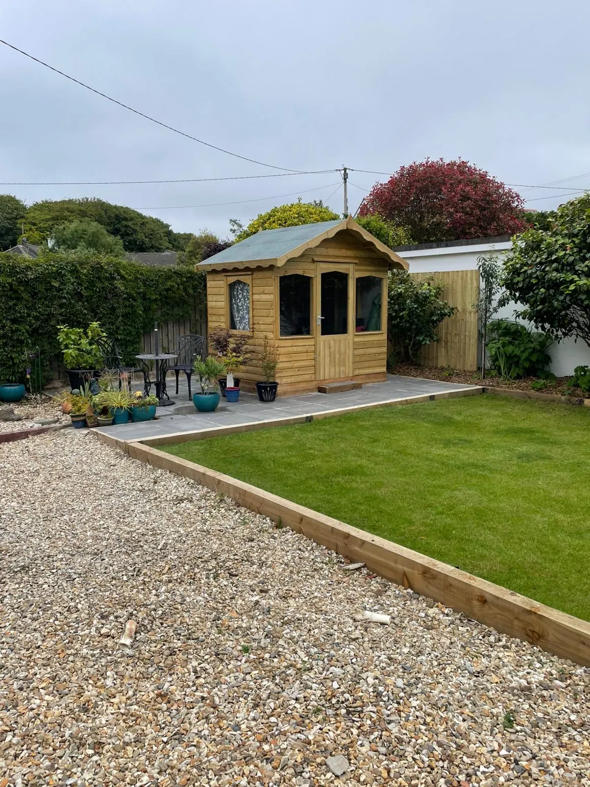 Finished timber summerhouse installed in a landscaped Cornwall garden