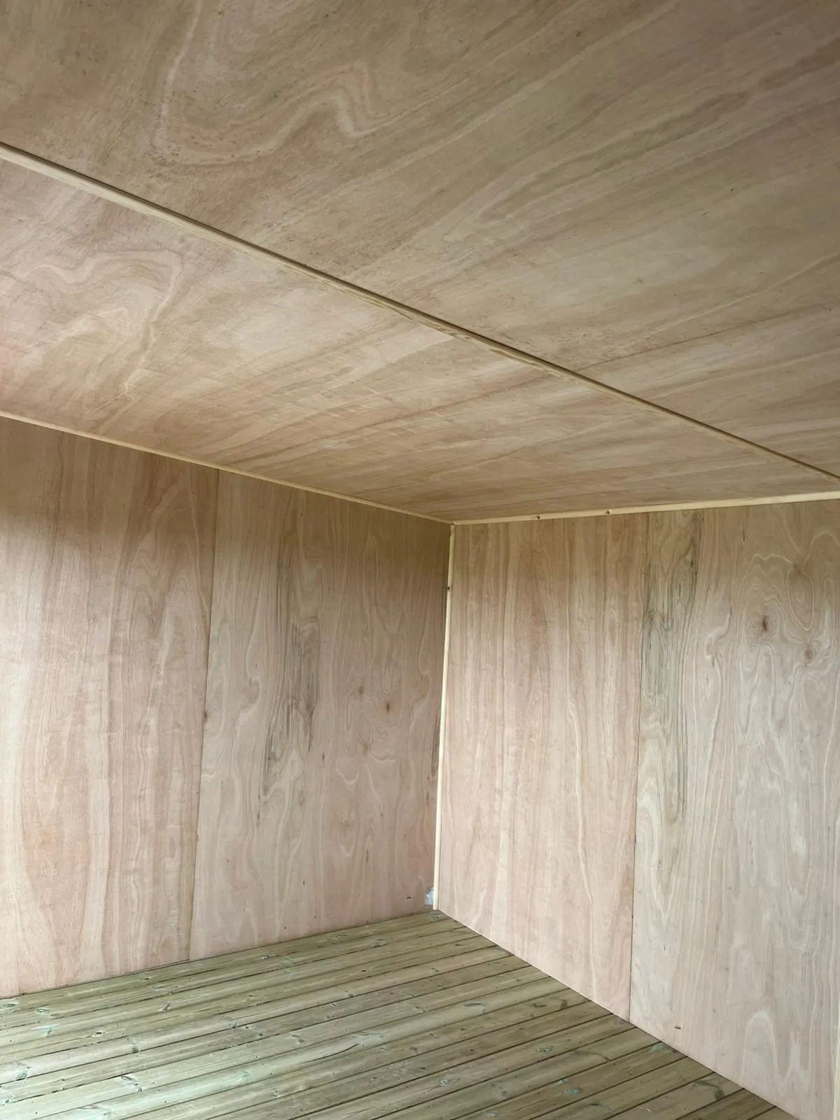 Plywood internal lining fitted to the walls and ceiling of a garden room