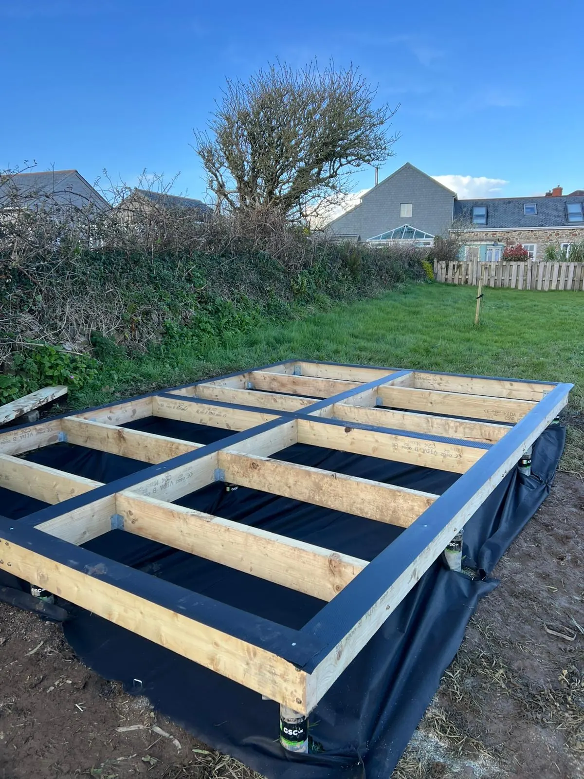 Ground screw timber base installed and levelled in a rural Cornwall garden