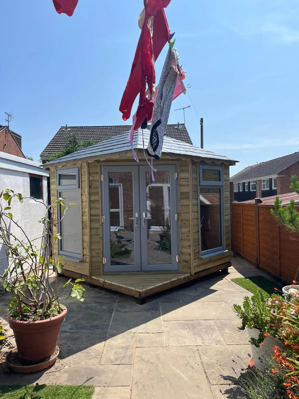 Completed octagonal timber summerhouse viewed from the garden