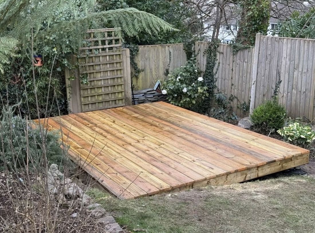Completed decking installation Cornwall — warm cedar finish