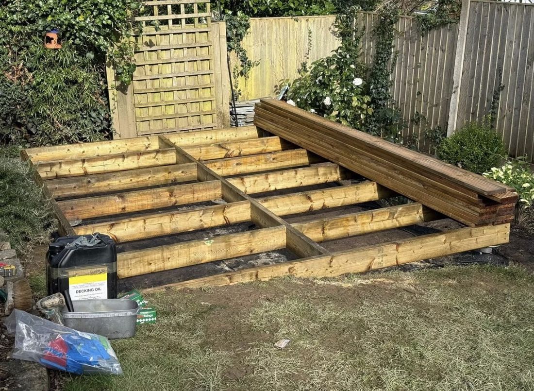 Boards down — completed timber decking base on ground screws