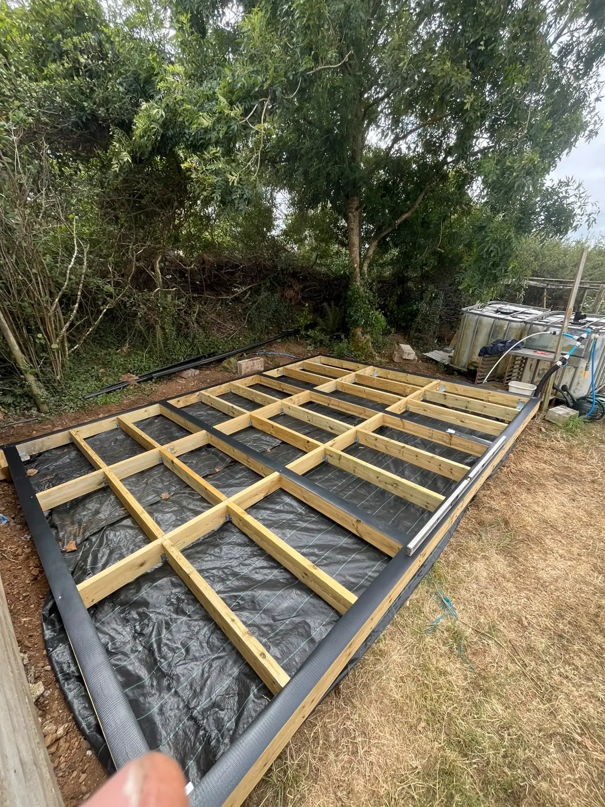 Treated timber subframe fixed and levelled over a ground screw foundation