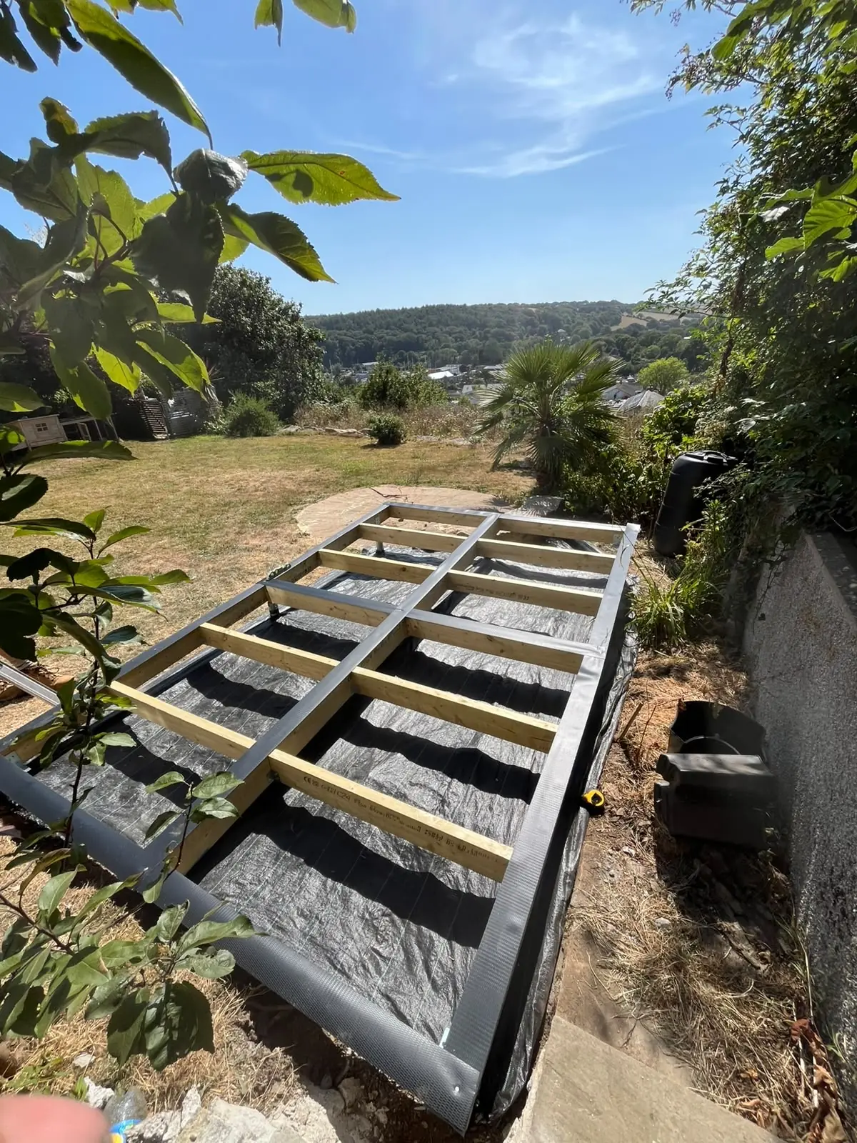 Level timber base installed in a sloping Cornwall garden